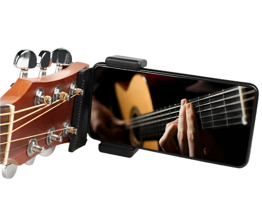 Smartphone with a guitar app displayed on screen held next to a guitar